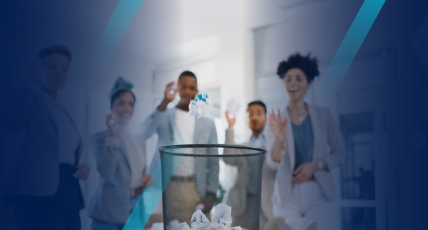 Employees tossing paper in waste basket symbolizing ditching a paper I-9 process
