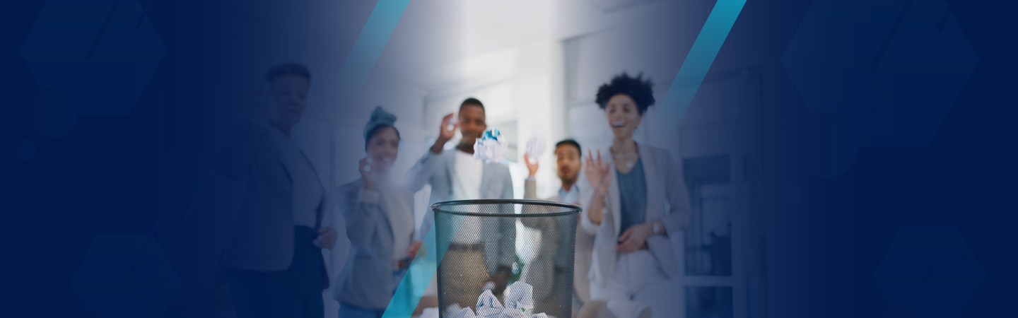 Employees tossing paper in waste basket symbolizing ditching a paper I-9 process