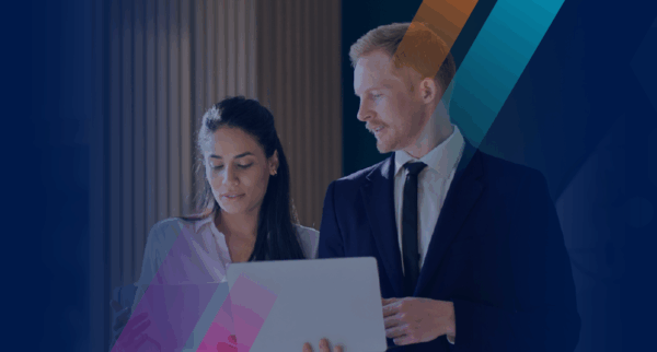 Blog banner image with two people standing at laptop reviewing risk quantification data.